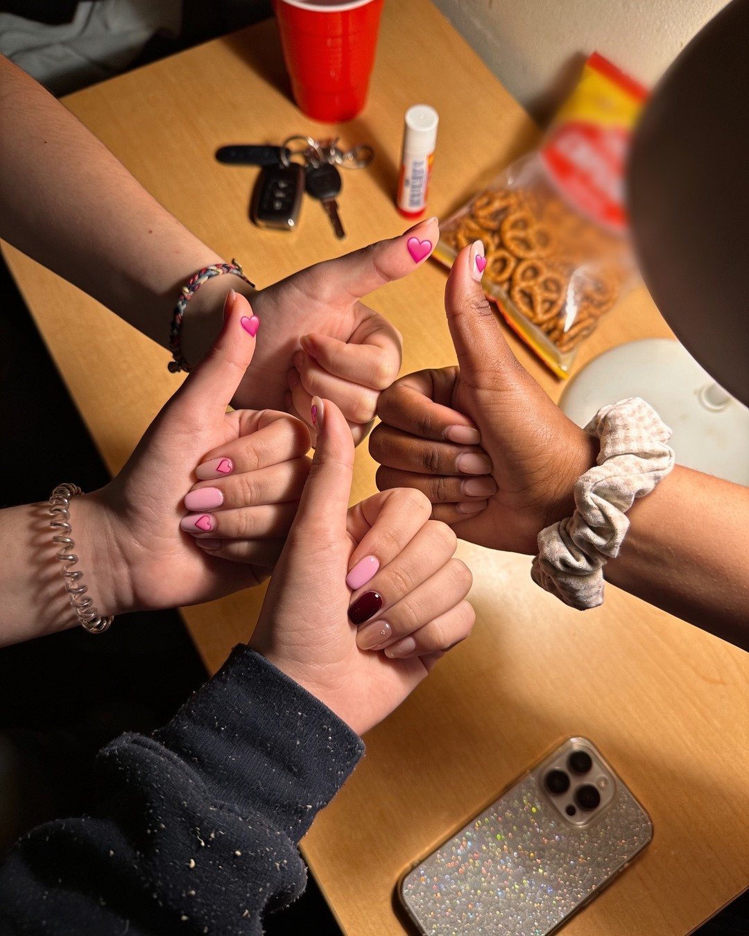 Friends showing their SafeNails heart stickers